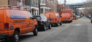 Mold Damage Restoration Vans And Trucks At Urban Job Location